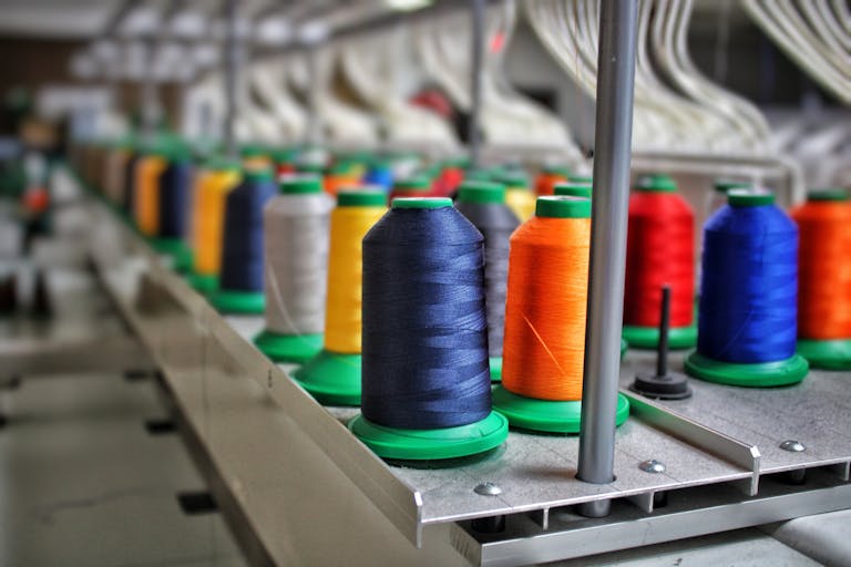 Close-up of Colorful Threads on Spools